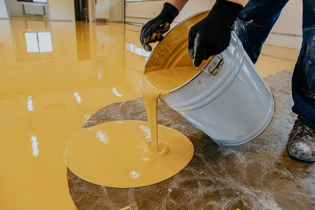 Epoxy resin applied to the floor. Industrial hall with colored floor